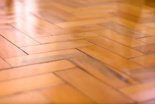 Glossy refinished floor catching warm light