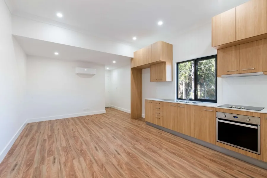 Open kitchen and living space over a warm brown wood floor