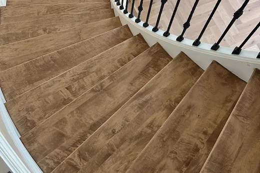 Curved staircase with warm brown treads