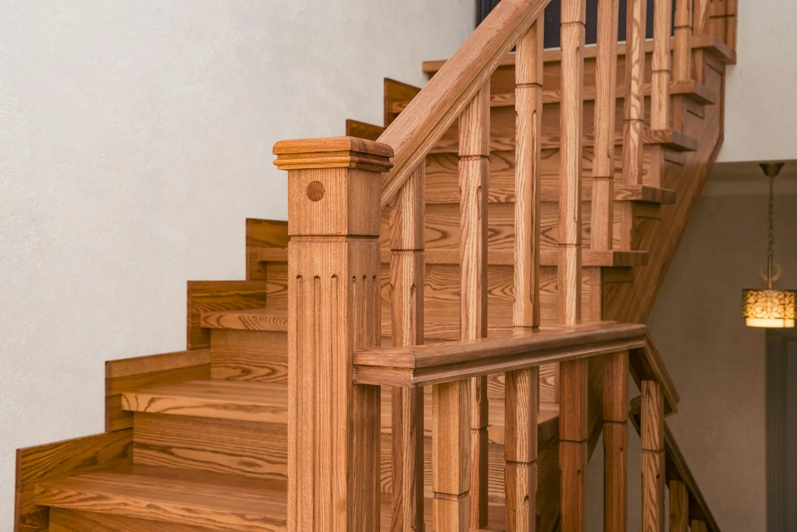 Traditional oak staircase with turned balusters and a square newel post