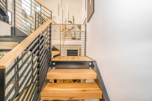 Wood stair treads with a steel railing