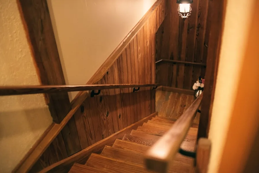 Warm wood stairwell lit by a pendant above the landing